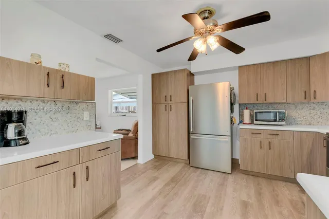 a view of kitchen with furniture and ceiling fan