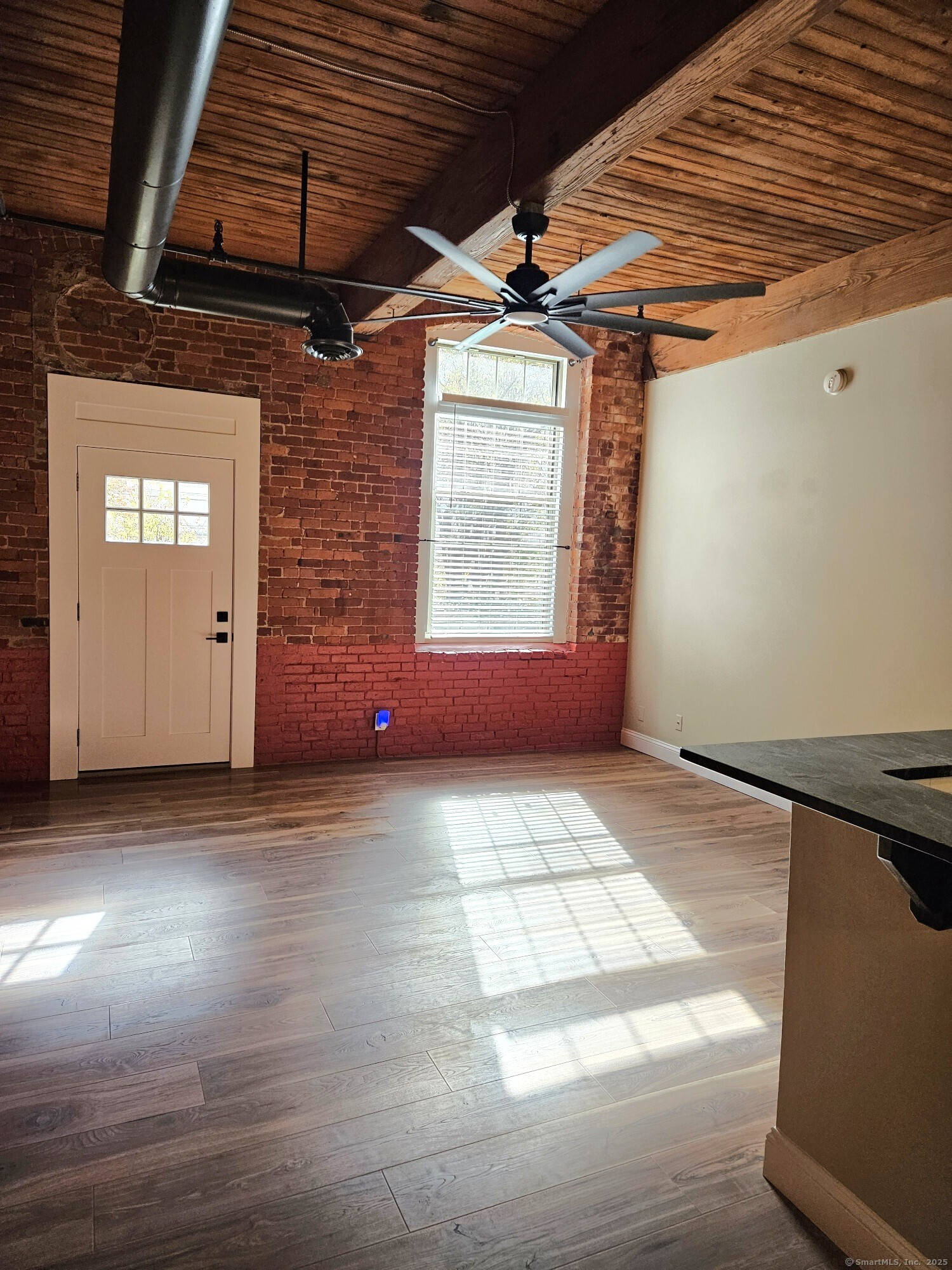 92 Main Street, Unit 101 Deep River, CT 06417 - Photo 12 of 16 a view of an empty room with a window