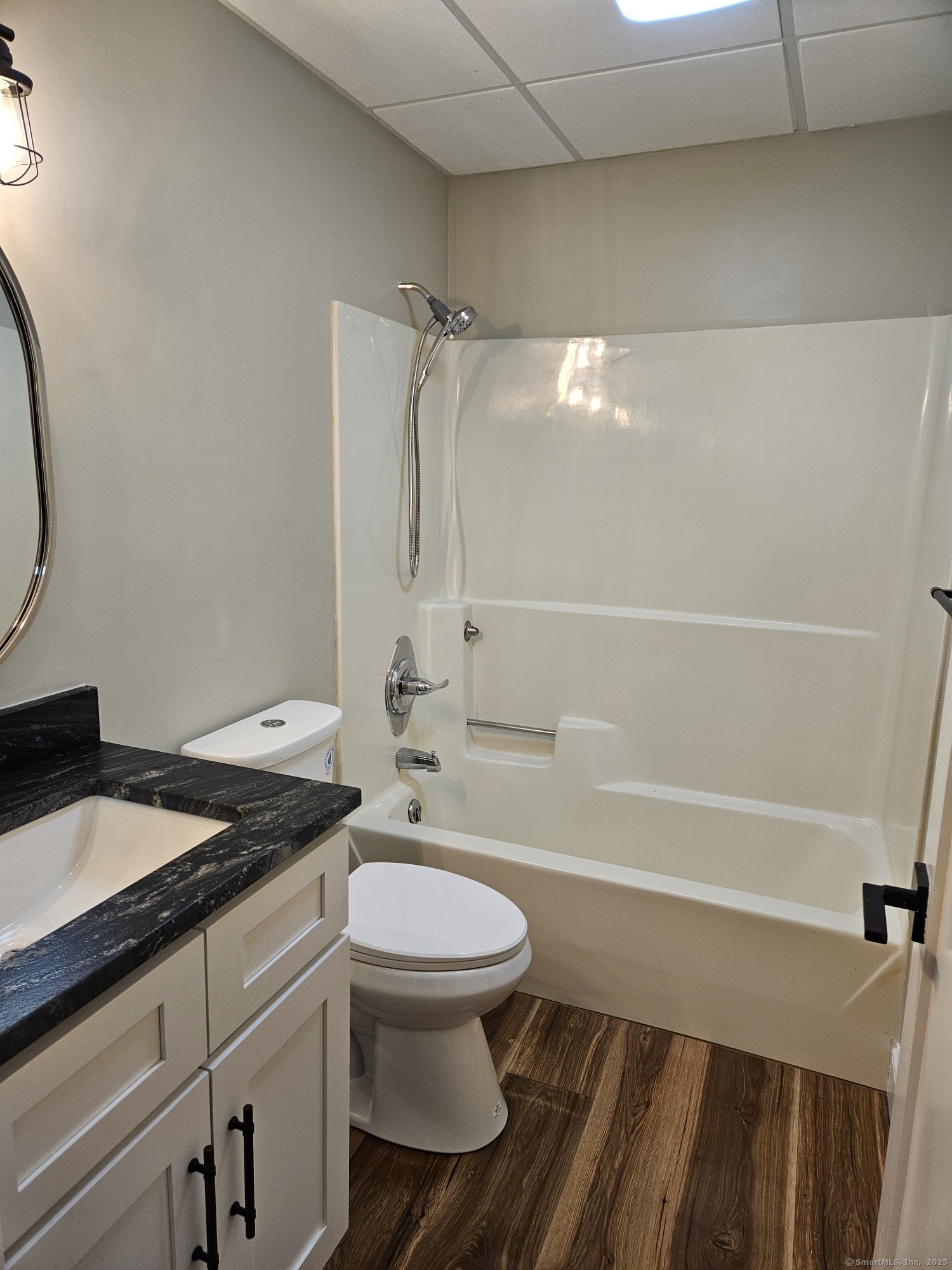 92 Main Street, Unit 101 Deep River, CT 06417 - Photo 5 of 16 a bathroom with a granite countertop toilet sink and shower