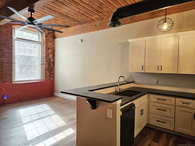 a kitchen that has a sink and a stove