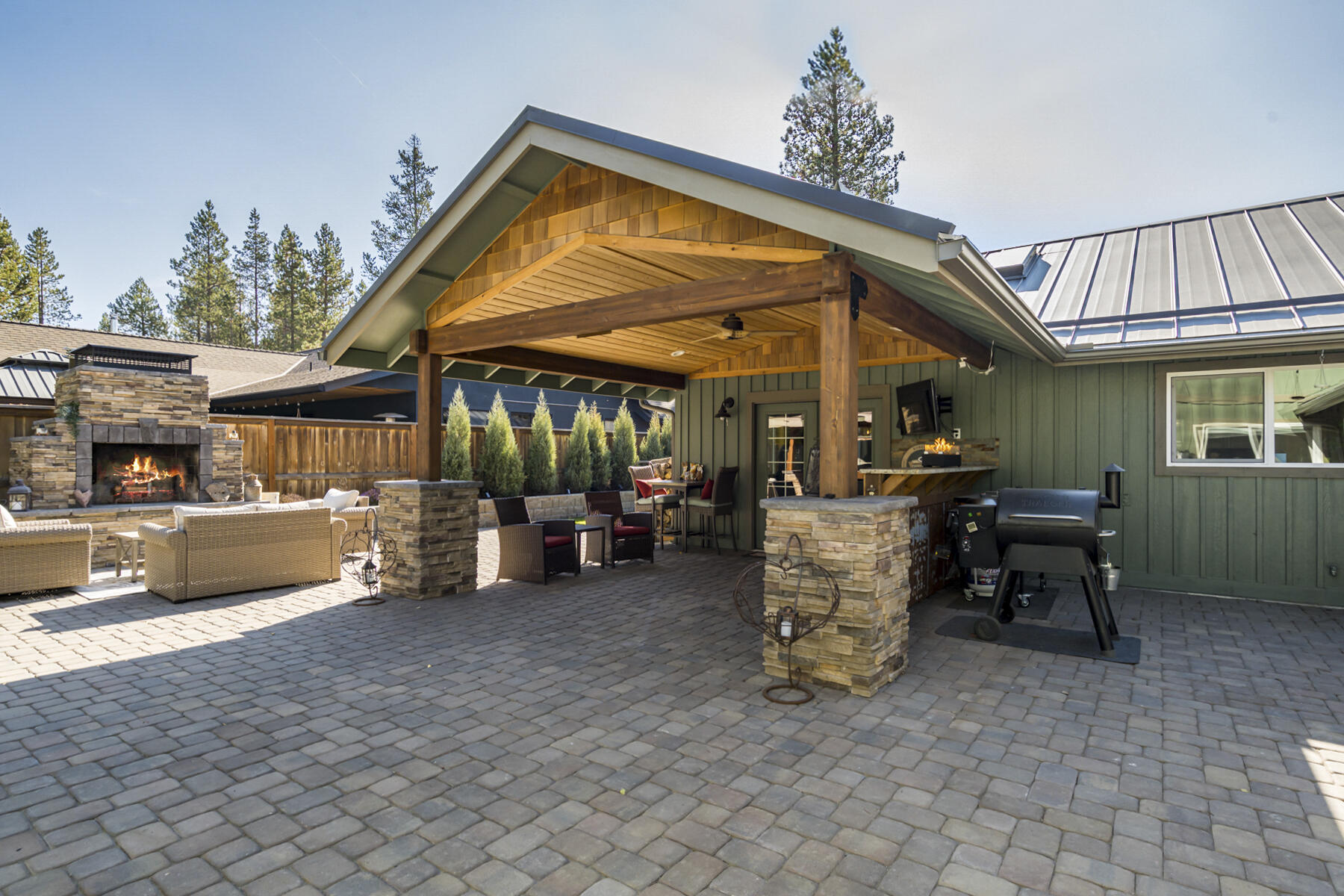 17246 Tholstrup Road Bend, OR 97707 - Photo 5 of 55 Extensive paver work, covered outdoor kitchen and stunning fireplace