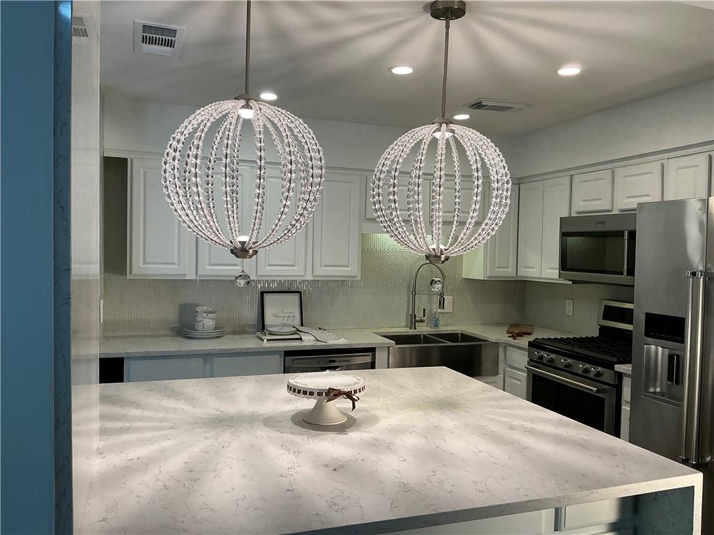 3823 Paces Ferry West Atlanta, GA 30339 - Photo 6 of 33 a kitchen with stainless steel appliances a sink a stove a microwave a refrigerator and cabinets