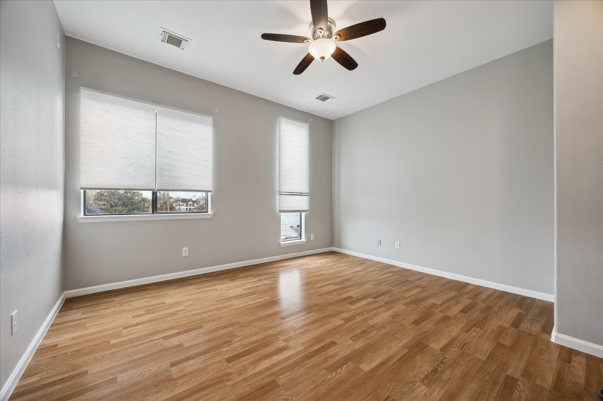 802 Waverly Street, Unit D Houston, TX 77007 - Photo 22 of 30 a view of empty room with wooden floor and fan