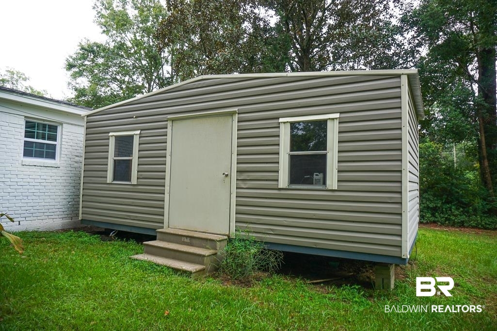 4734 Kirkwell Drive Mobile, AL 36619 - Photo 17 of 18 View of outbuilding with a lawn