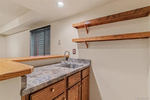 a bathroom with a granite countertop sink and a window