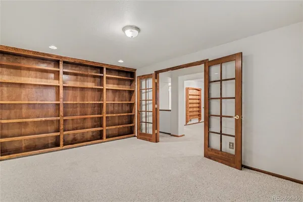a view of an empty room with a empty shelves and a window