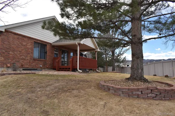 a front view of a house with a tree