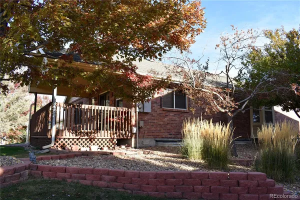 a view of a house with a small yard and wooden fence