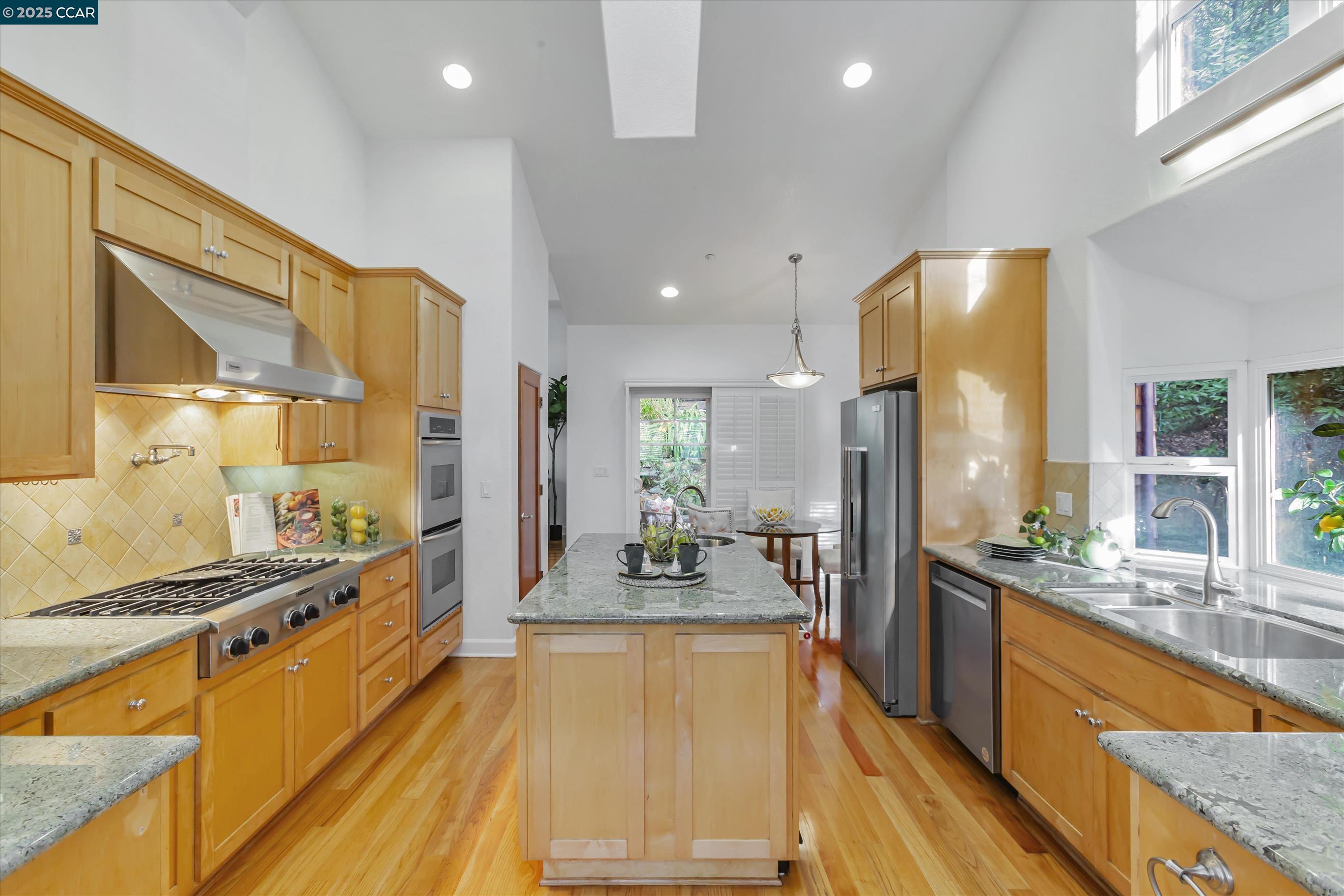 1215 Alvarado Road Berkeley, CA 94705 - Photo 13 of 52 a large kitchen with stainless steel appliances a large counter top a stove a sink and a refrigerator
