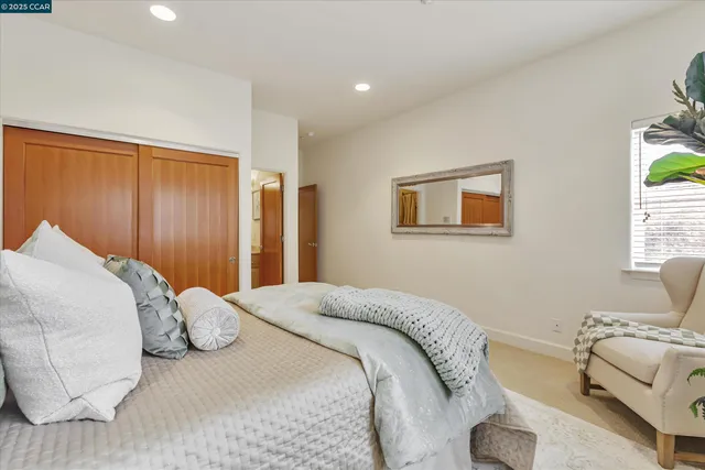 a bed room with a bed and a potted plant