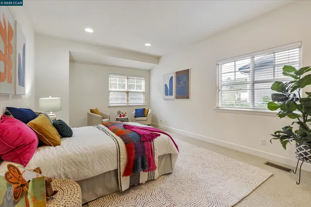 a bed sitting in a bedroom next to a window