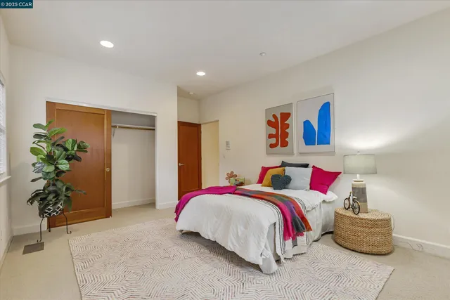 a bedroom with bed and night stand