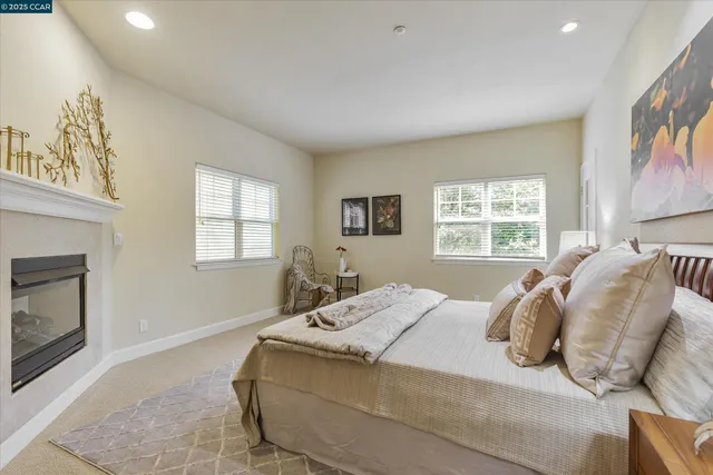 a bedroom with a bed and a fireplace