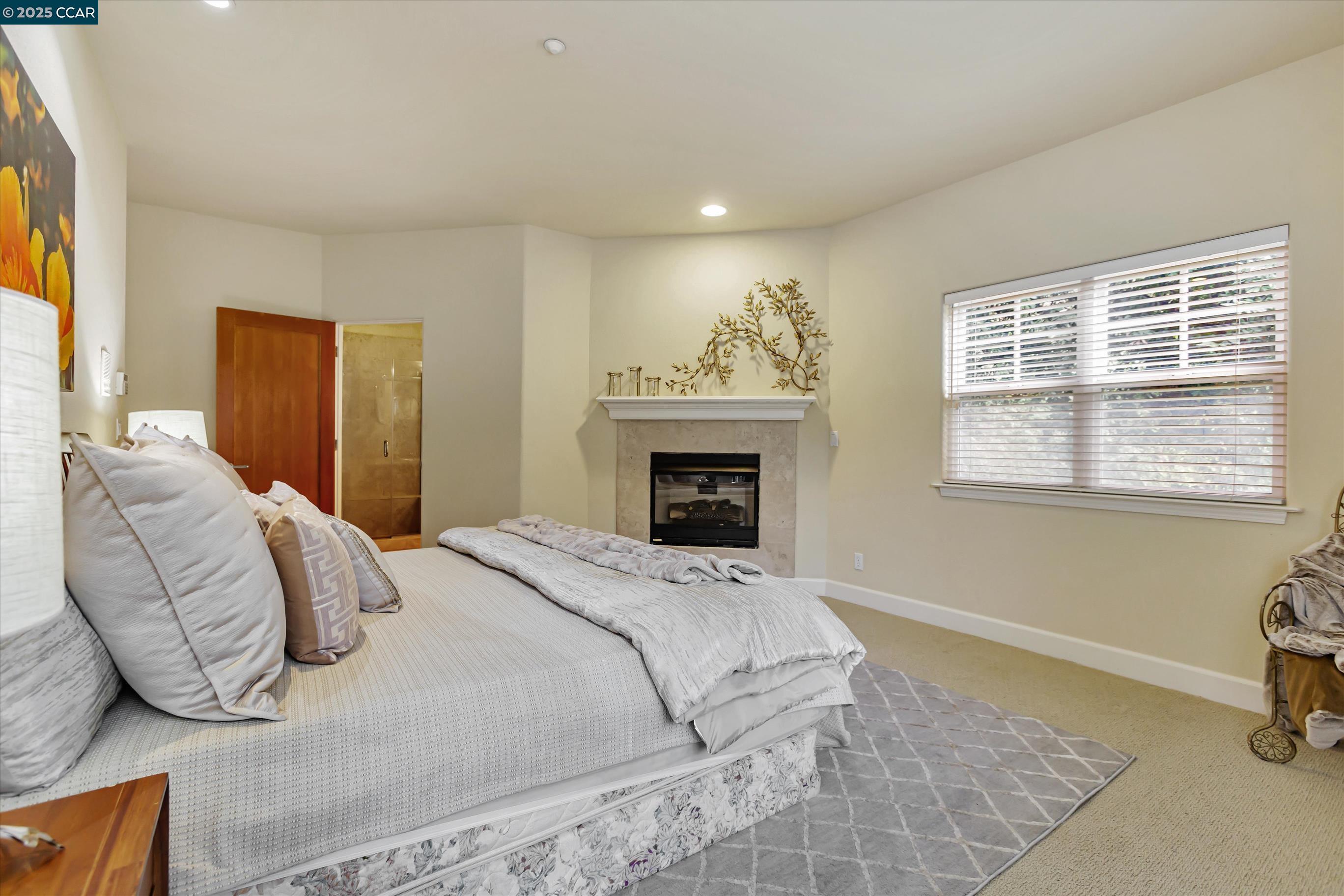 1215 Alvarado Road Berkeley, CA 94705 - Photo 28 of 52 a bedroom with a bed and a fireplace
