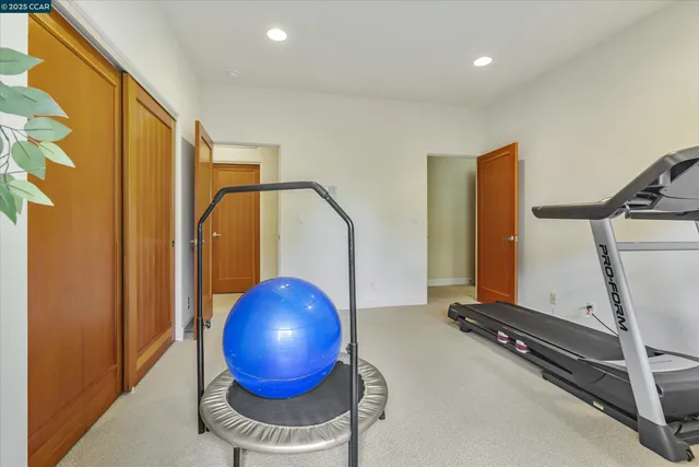 a room with gym equipment and a large window