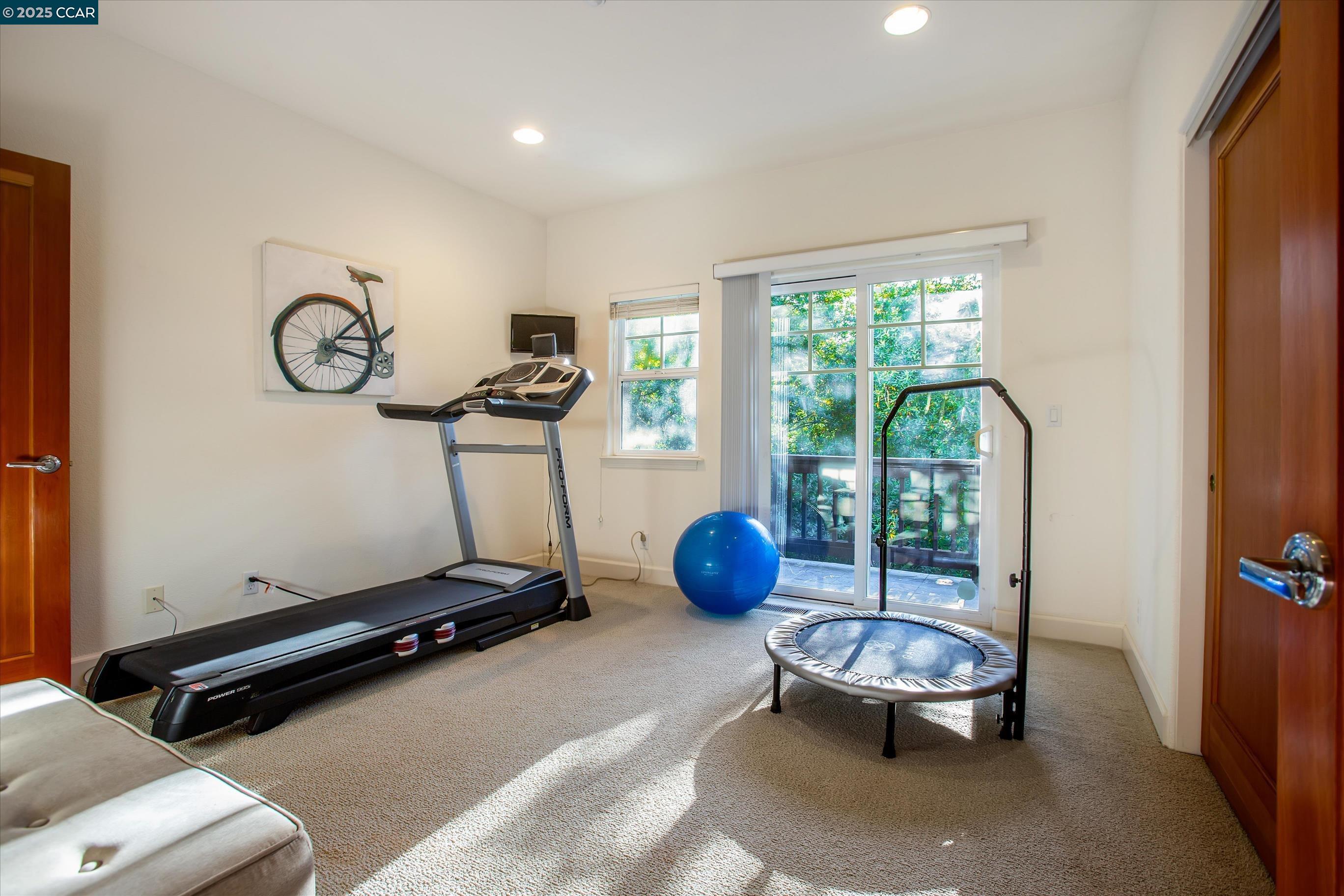 1215 Alvarado Road Berkeley, CA 94705 - Photo 33 of 52 a room with gym equipment and a large window