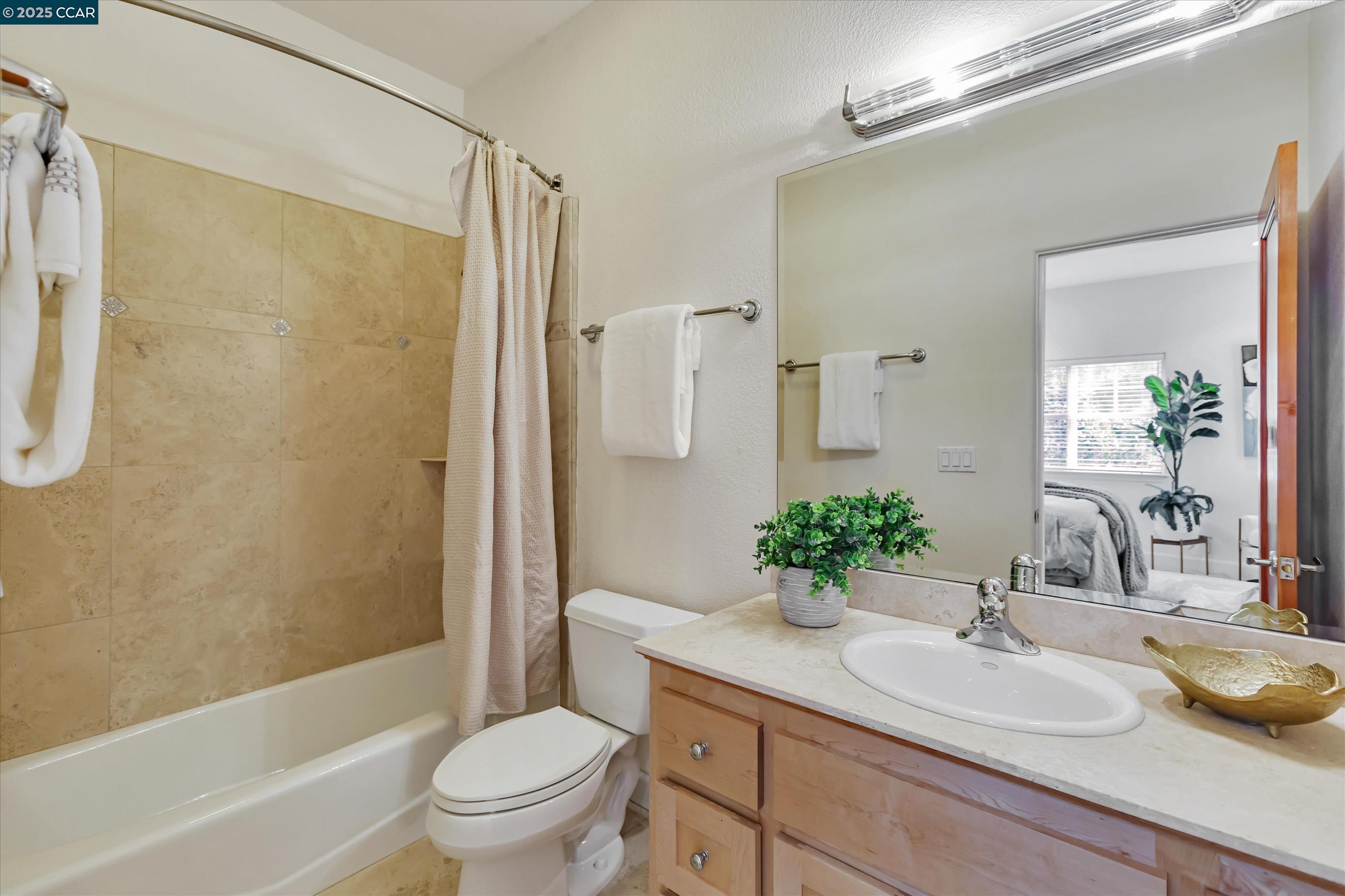 1215 Alvarado Road Berkeley, CA 94705 - Photo 35 of 52 a bathroom with a granite countertop sink a toilet and shower