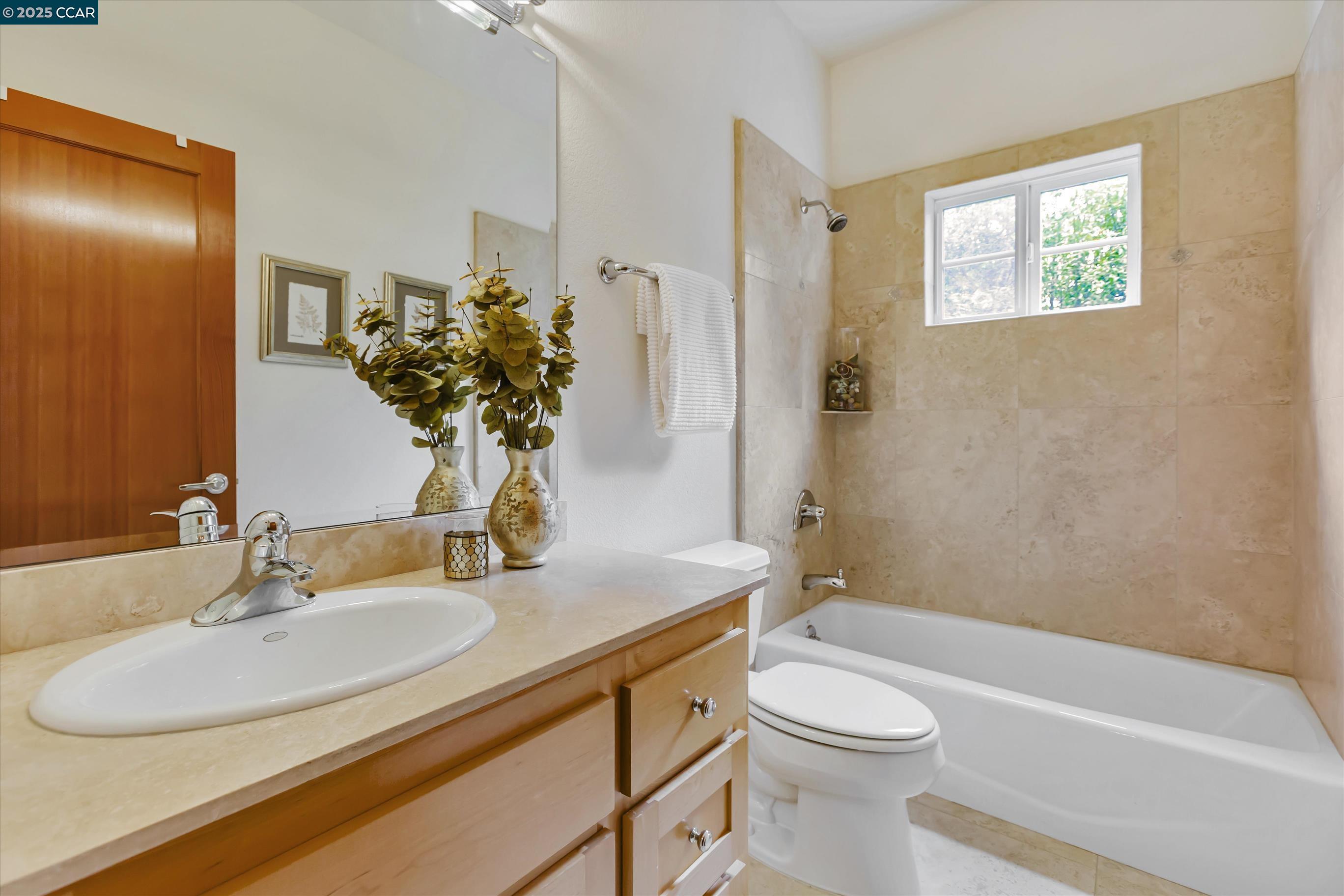 1215 Alvarado Road Berkeley, CA 94705 - Photo 36 of 52 a bathroom with a sink a toilet and shower