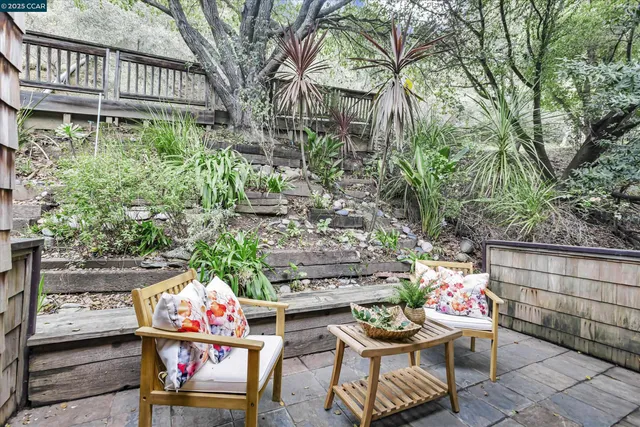 a view of livingroom with deck and a garden