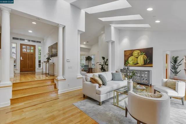 a living room with fireplace furniture and a large window