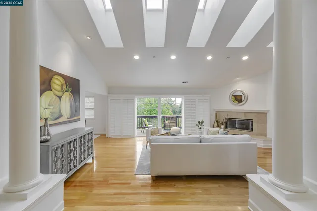 a living room with furniture fireplace and wooden floor