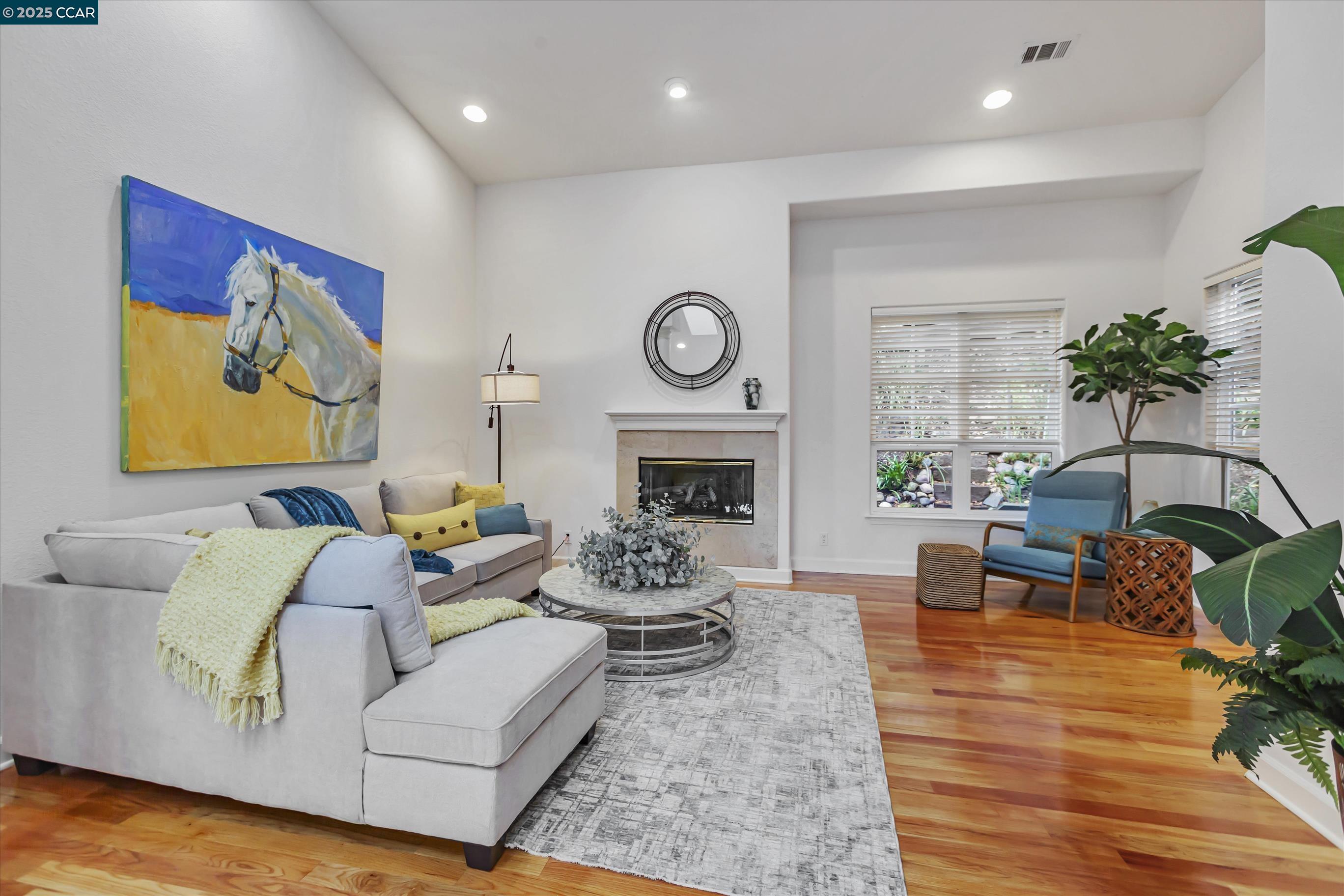 1215 Alvarado Road Berkeley, CA 94705 - Photo 10 of 52 a living room with furniture fireplace and wooden floor