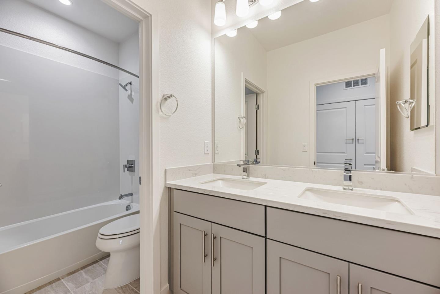 5005 Seashell Terrace San Ramon, CA 94583 - Photo 17 of 19 a bathroom with a granite countertop sink a toilet and a large mirror