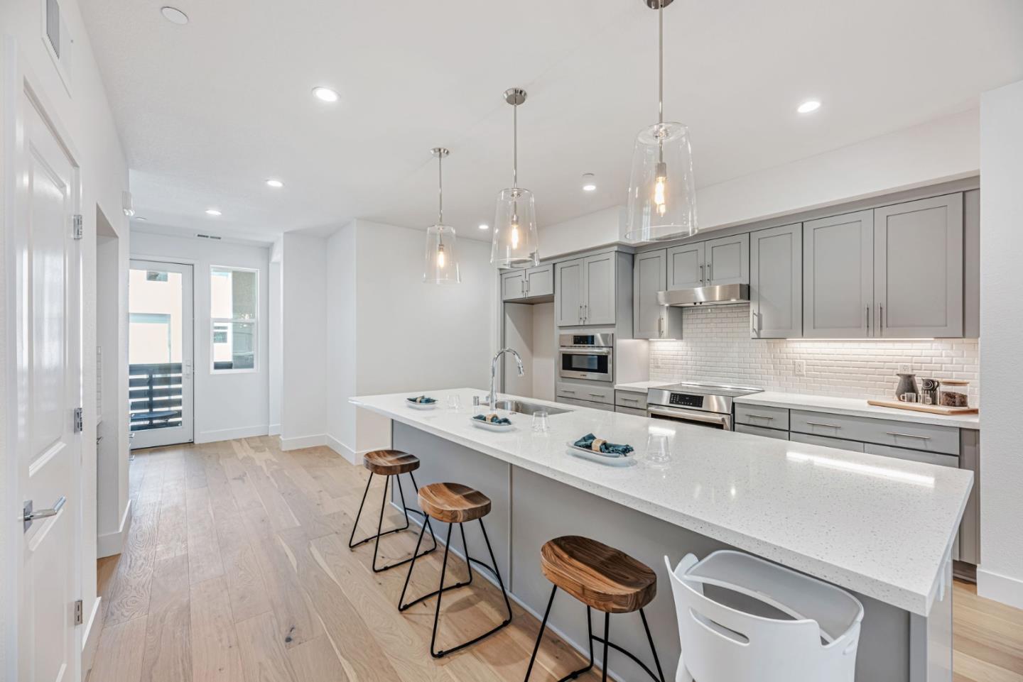 5005 Seashell Terrace San Ramon, CA 94583 - Photo 4 of 19 a kitchen with stainless steel appliances granite countertop a sink a stove a refrigerator and island with wooden floor
