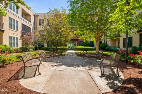 a view of a swimming pool with lawn chairs and plants