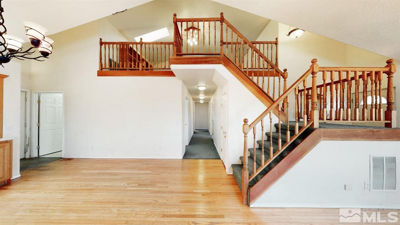 2141 Lousetown Road Reno, NV 89521 - Photo 8 of 40 a view of staircase with lots of frames on wall and wooden floor