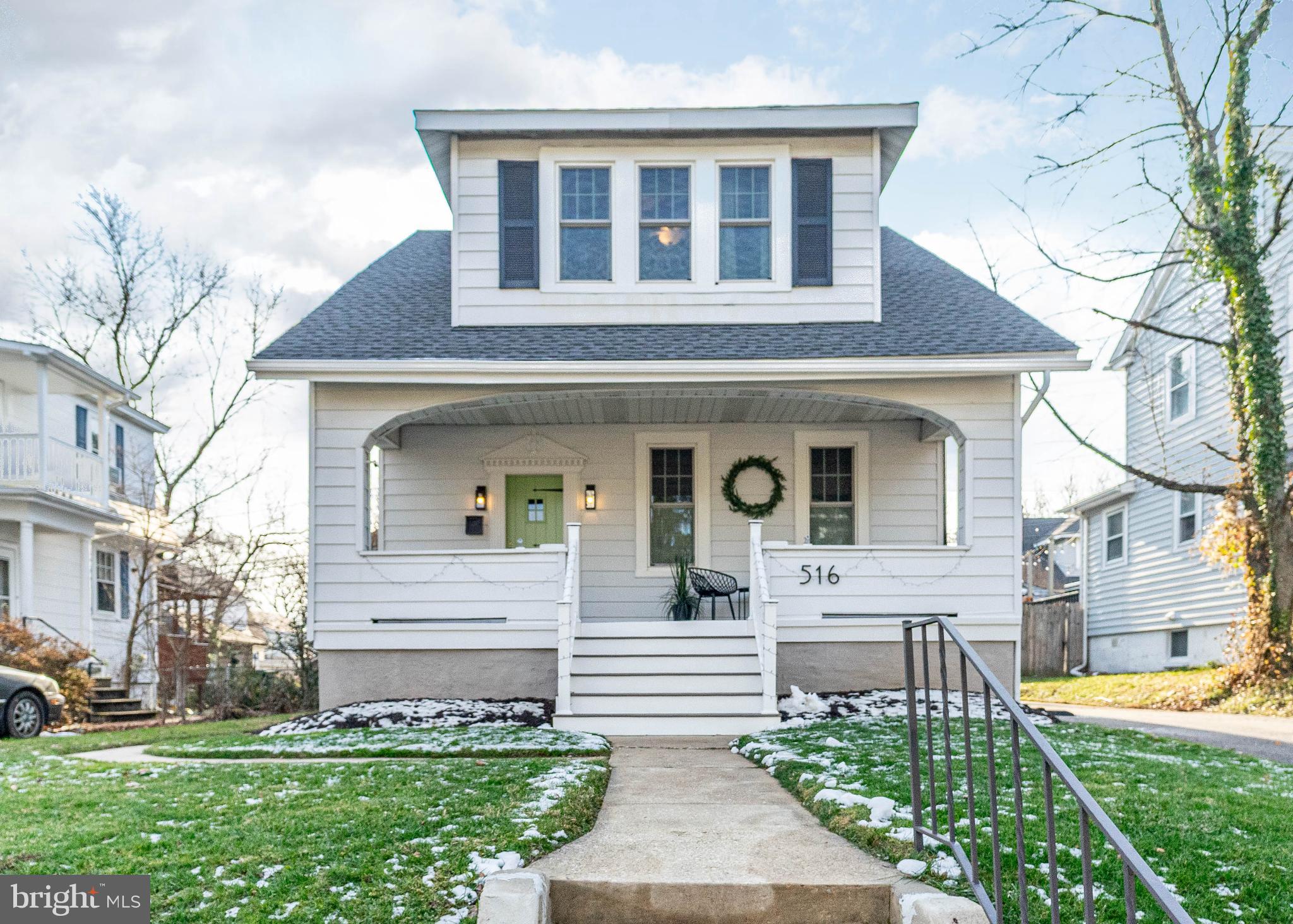 Charming home with inviting porch and greenery.