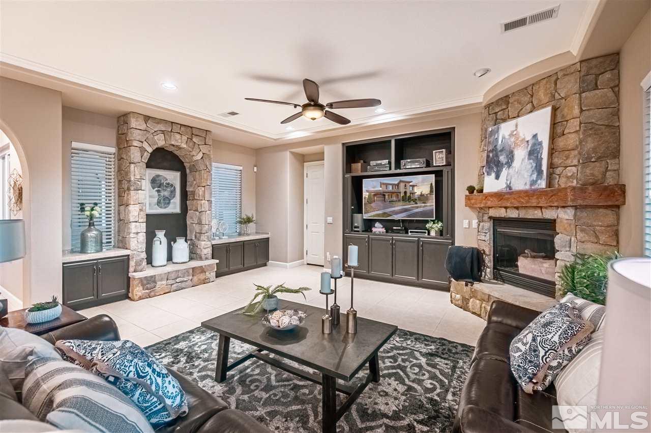 2610 Fury Court Reno, NV 89521 - Photo 11 of 25 a living room with furniture a large window and a fireplace