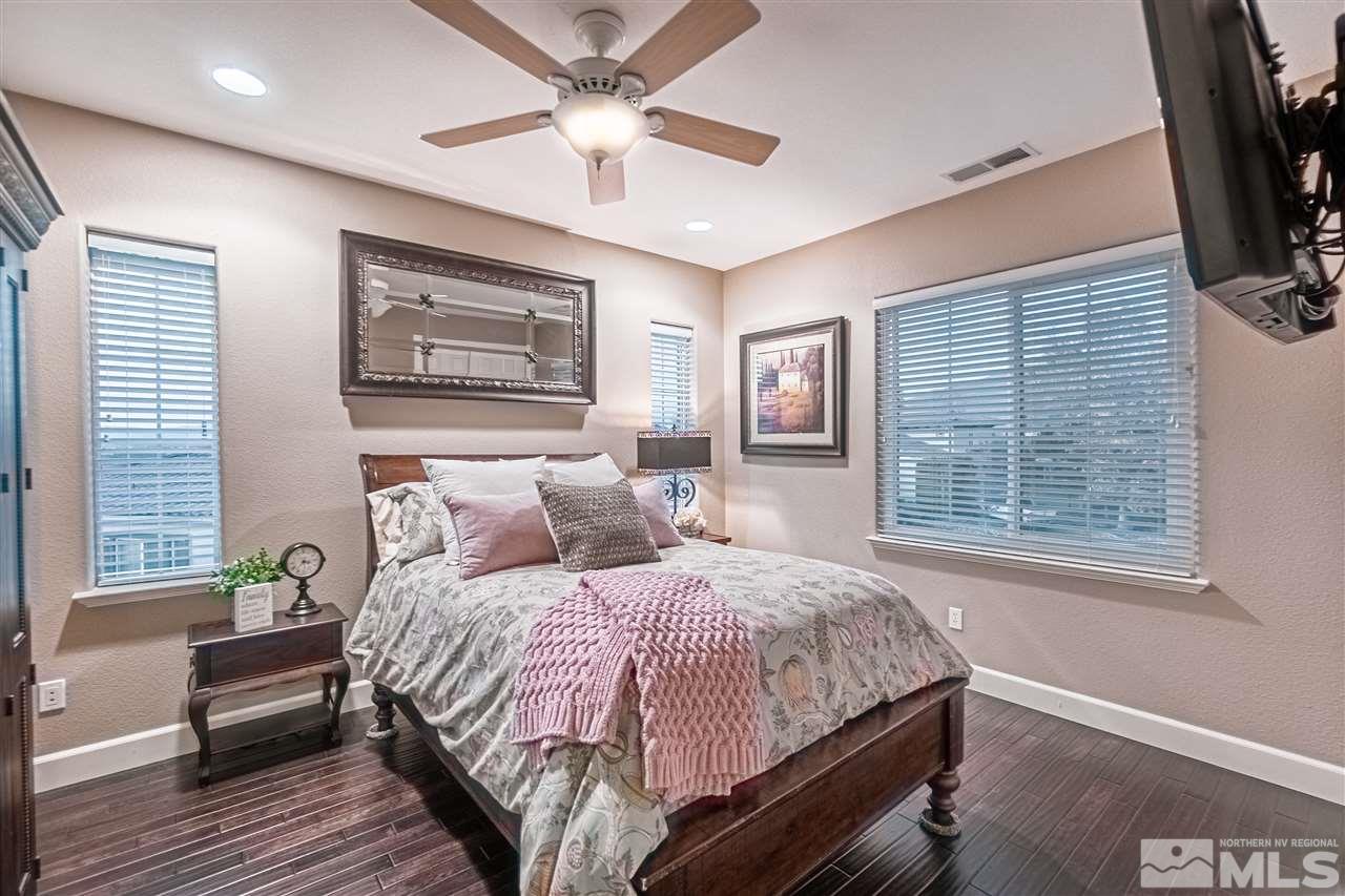 2610 Fury Court Reno, NV 89521 - Photo 20 of 25 a bedroom with a large bed a flat tv screen and a dresser