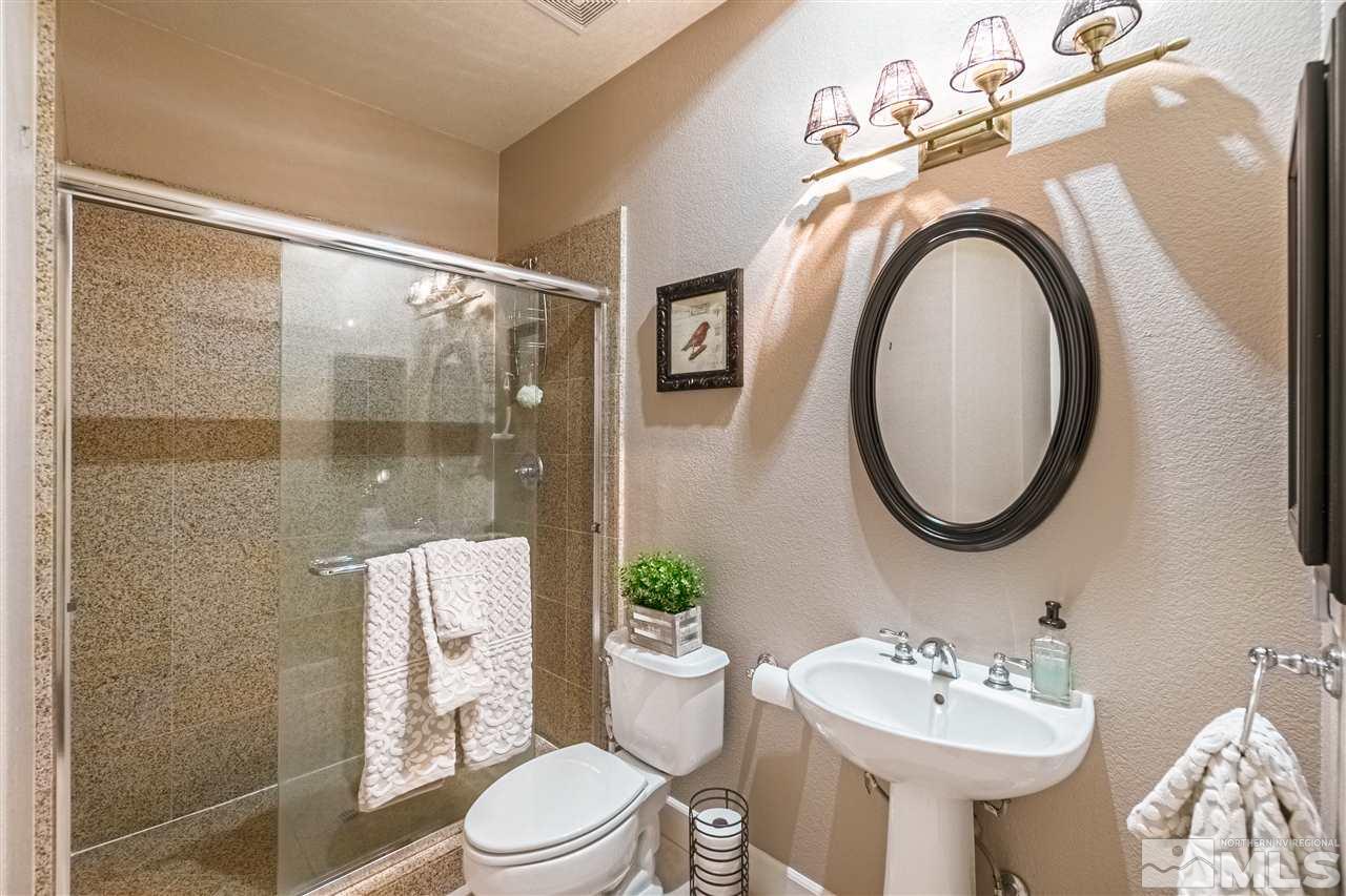 2610 Fury Court Reno, NV 89521 - Photo 22 of 25 a bathroom with a sink a toilet and a mirror
