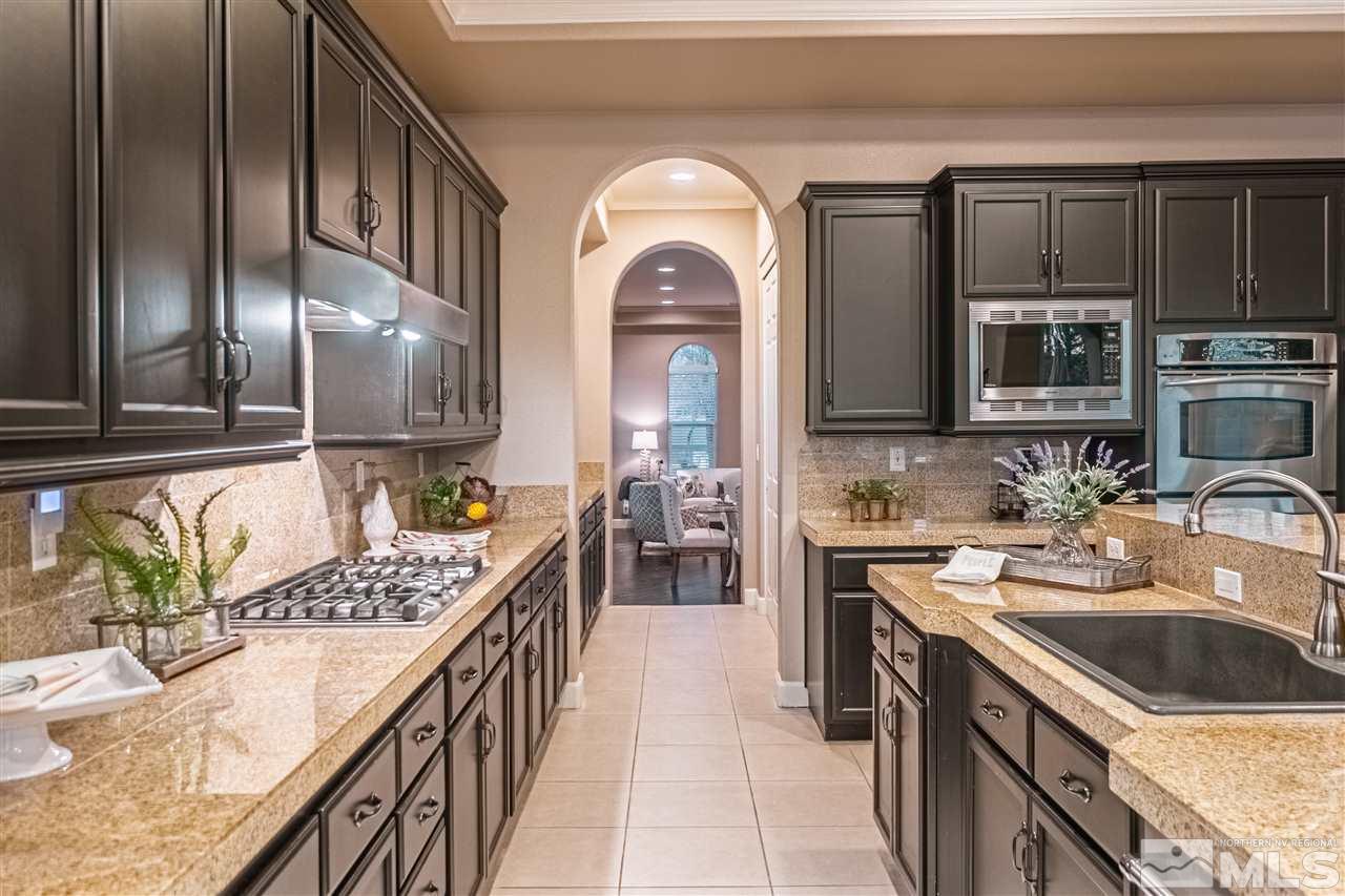 2610 Fury Court Reno, NV 89521 - Photo 4 of 25 a kitchen with stainless steel appliances granite countertop a stove a sink and a microwave