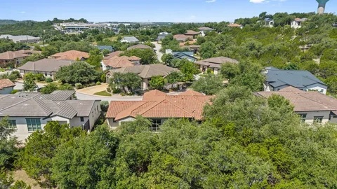 an aerial view of multiple houses with a yard