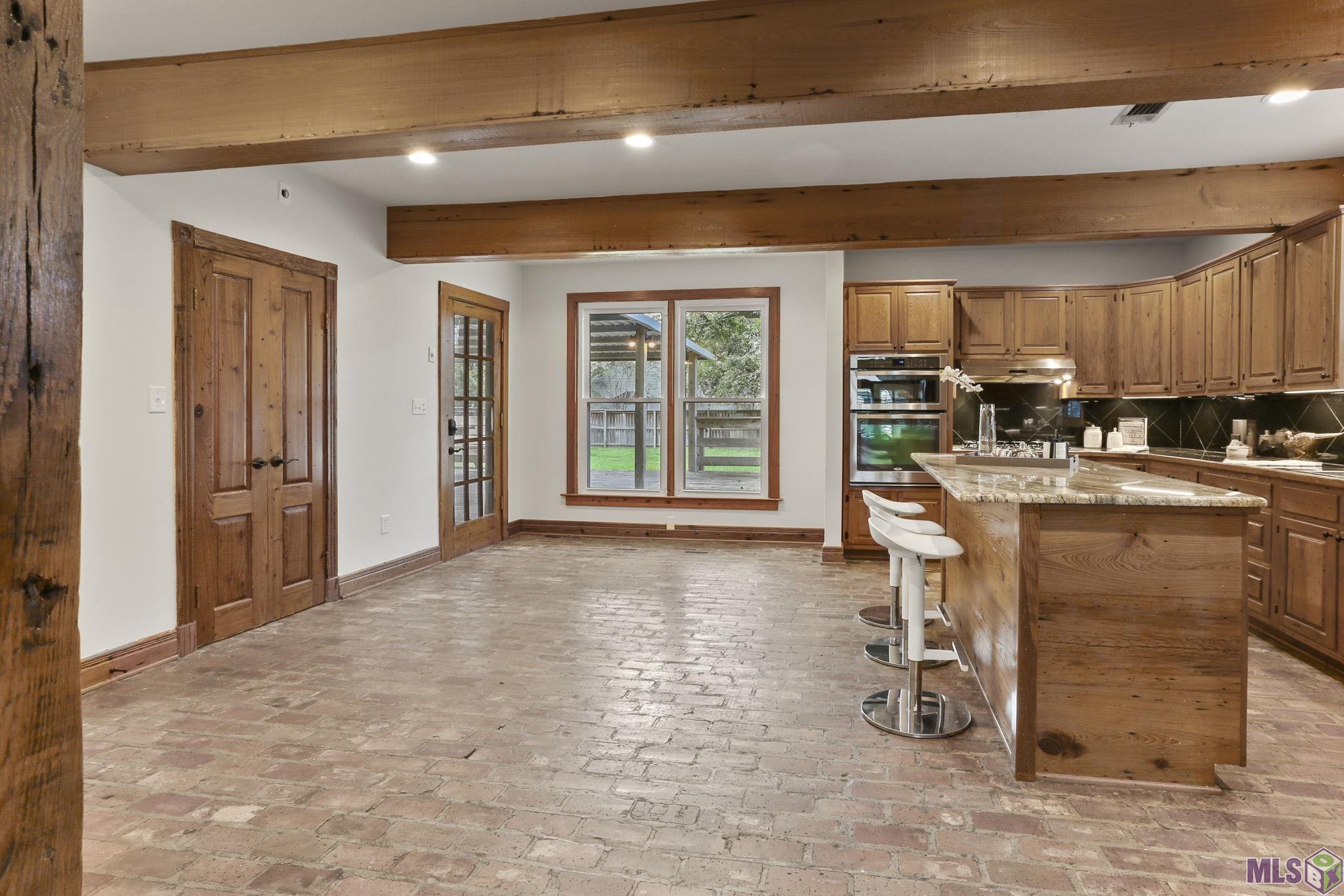 4613 Tupello Street Baton Rouge, LA 70808 - Photo 4 of 16 Open kitchen with real brick floors & Beautiful beams
