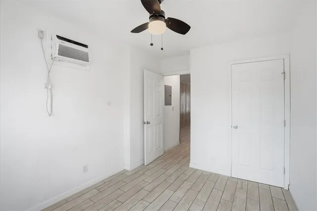 a view of an empty room and wooden floor