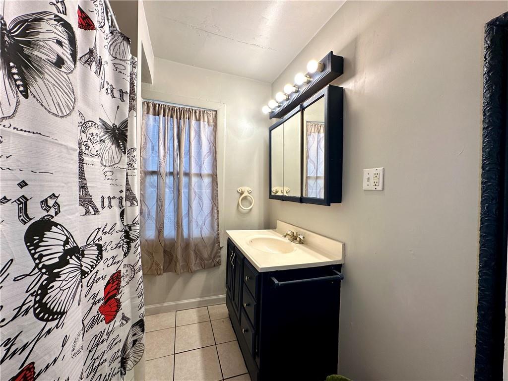 114 South Street Butler, PA 16001 - Photo 14 of 32 a bathroom with a bathtub sink and mirror