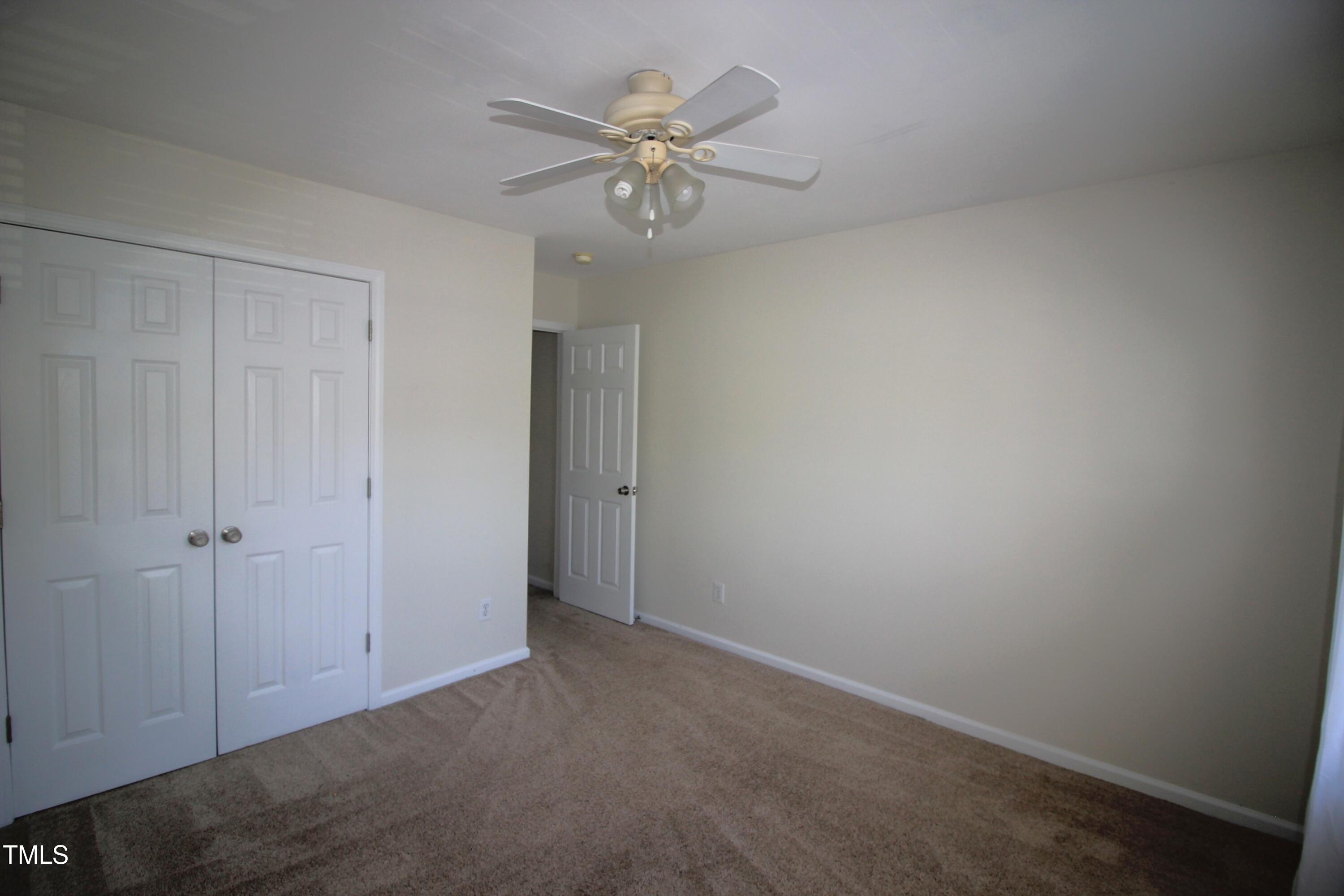 2201 Valley Haven Drive Raleigh, NC 27603 - Photo 13 of 16 a view of an empty room with a ceiling fan