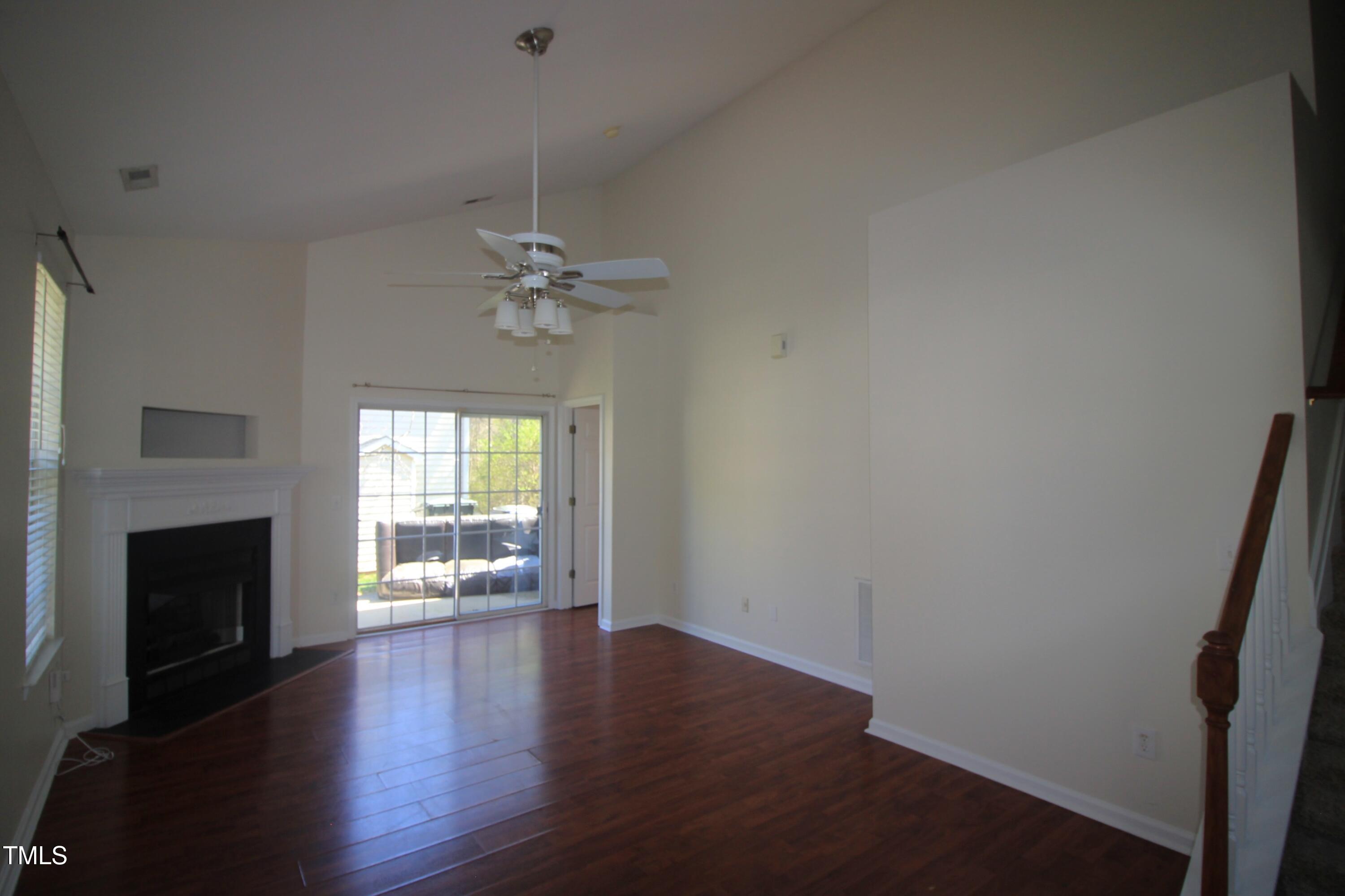 2201 Valley Haven Drive Raleigh, NC 27603 - Photo 3 of 16 a view of an empty room with a fireplace and a window