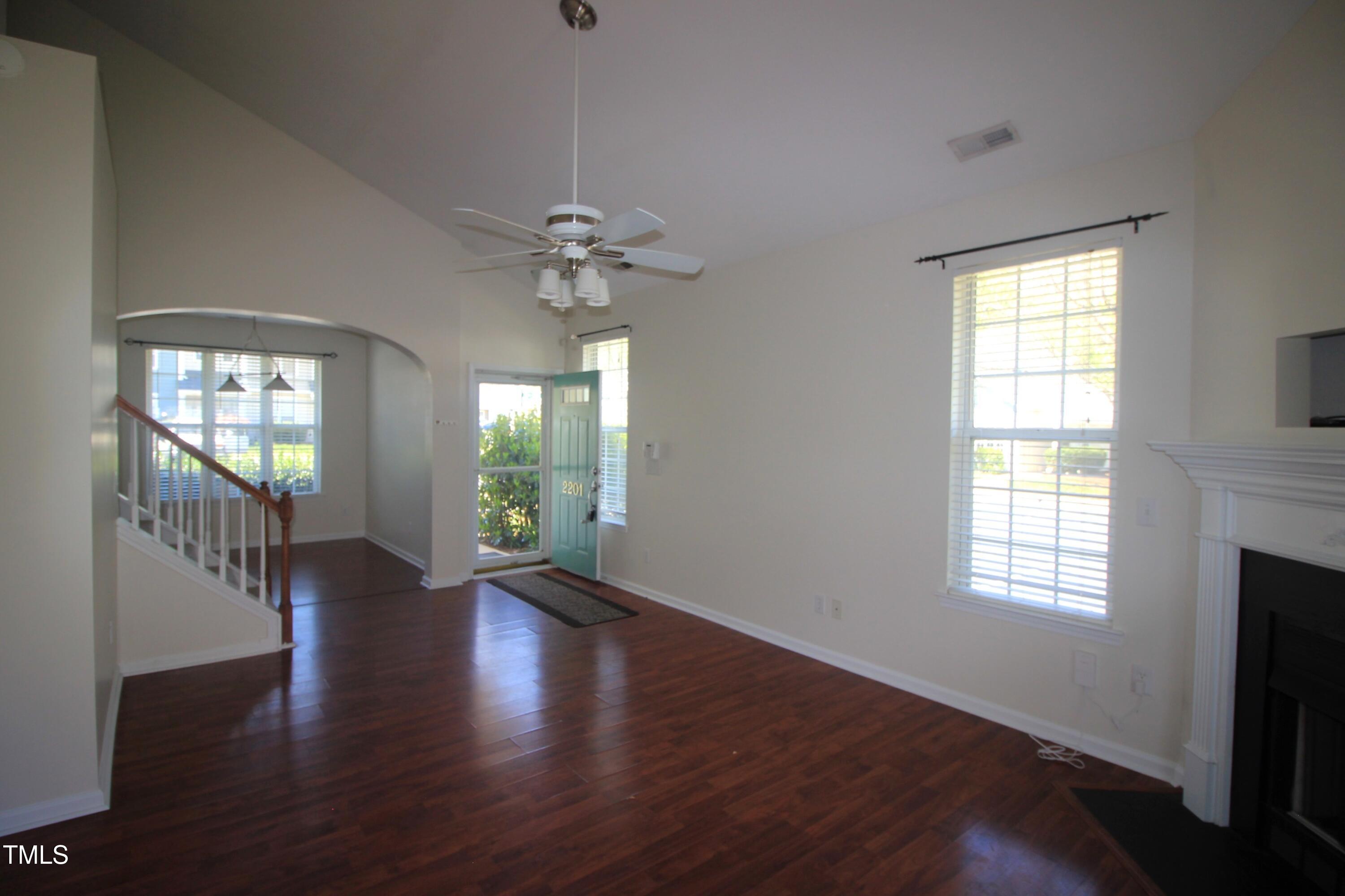 2201 Valley Haven Drive Raleigh, NC 27603 - Photo 4 of 16 a view of an empty room with wooden floor and a window