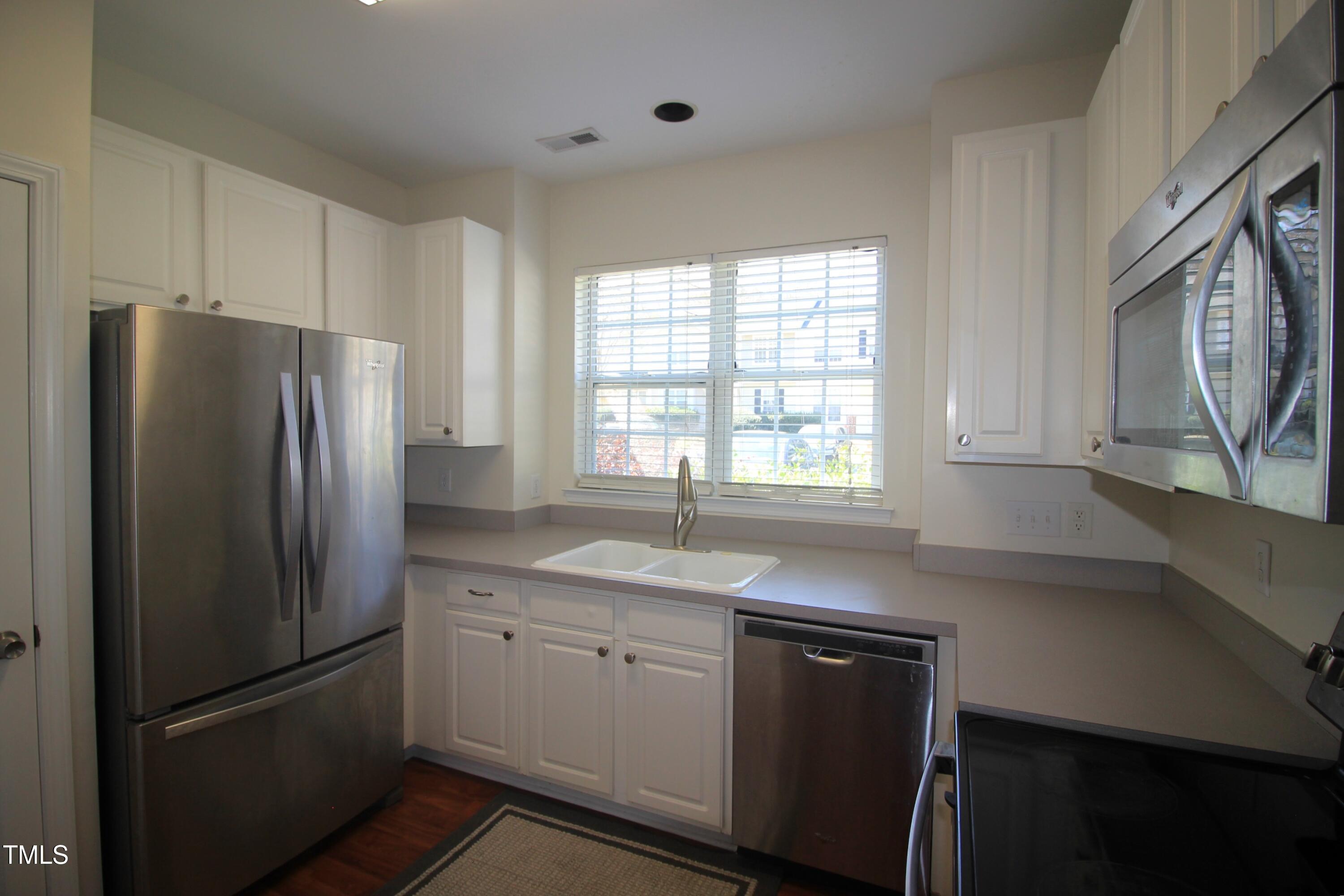 2201 Valley Haven Drive Raleigh, NC 27603 - Photo 7 of 16 a kitchen with a refrigerator sink and cabinets