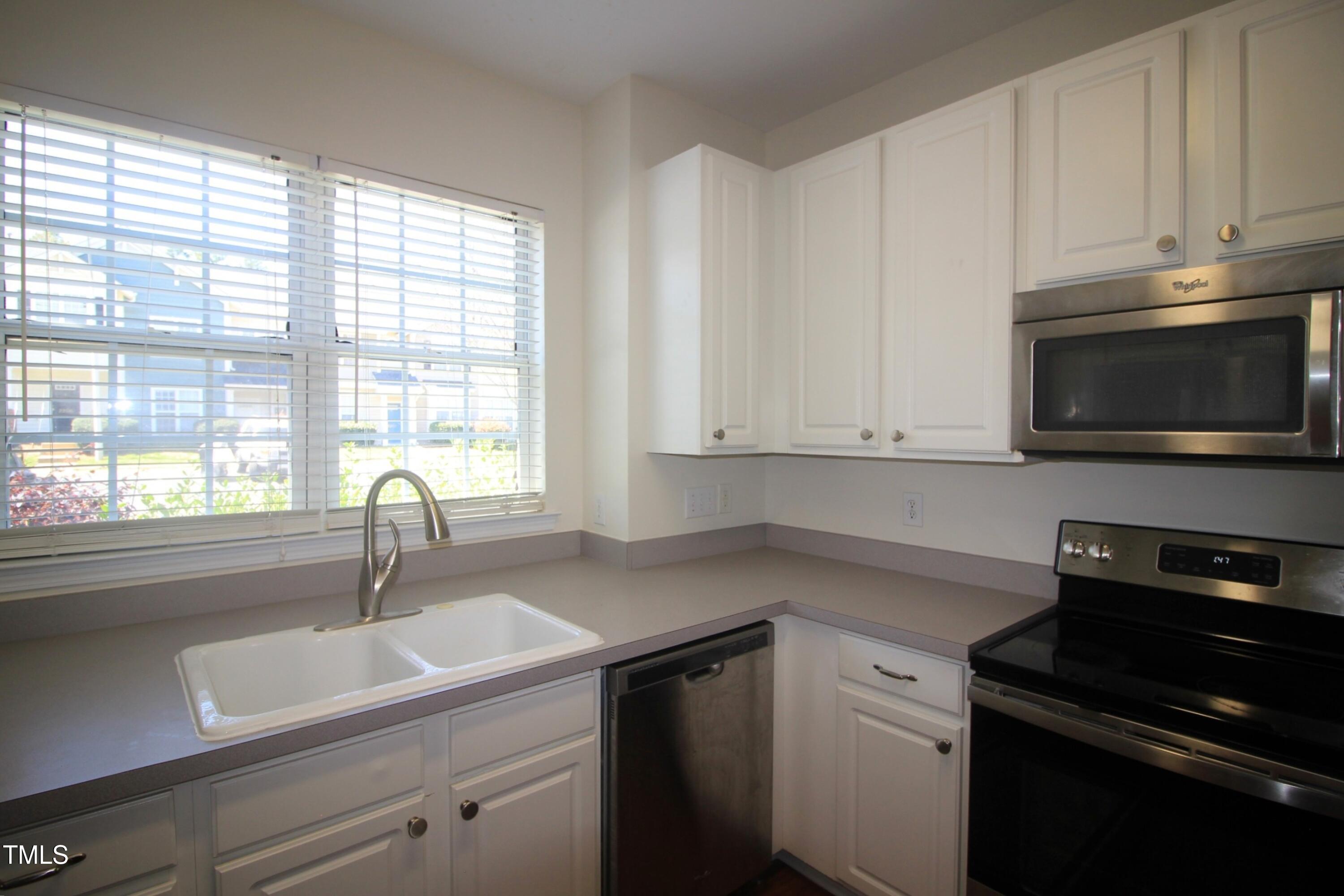 2201 Valley Haven Drive Raleigh, NC 27603 - Photo 8 of 16 a kitchen with a sink stove and microwave