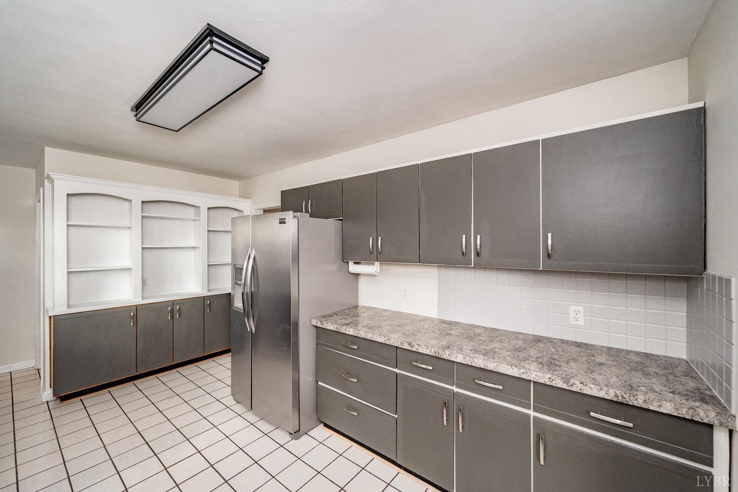 4925 Old Boonsboro Road Lynchburg, VA 24503 - Photo 11 of 57 a kitchen with stainless steel appliances granite countertop a refrigerator and a sink