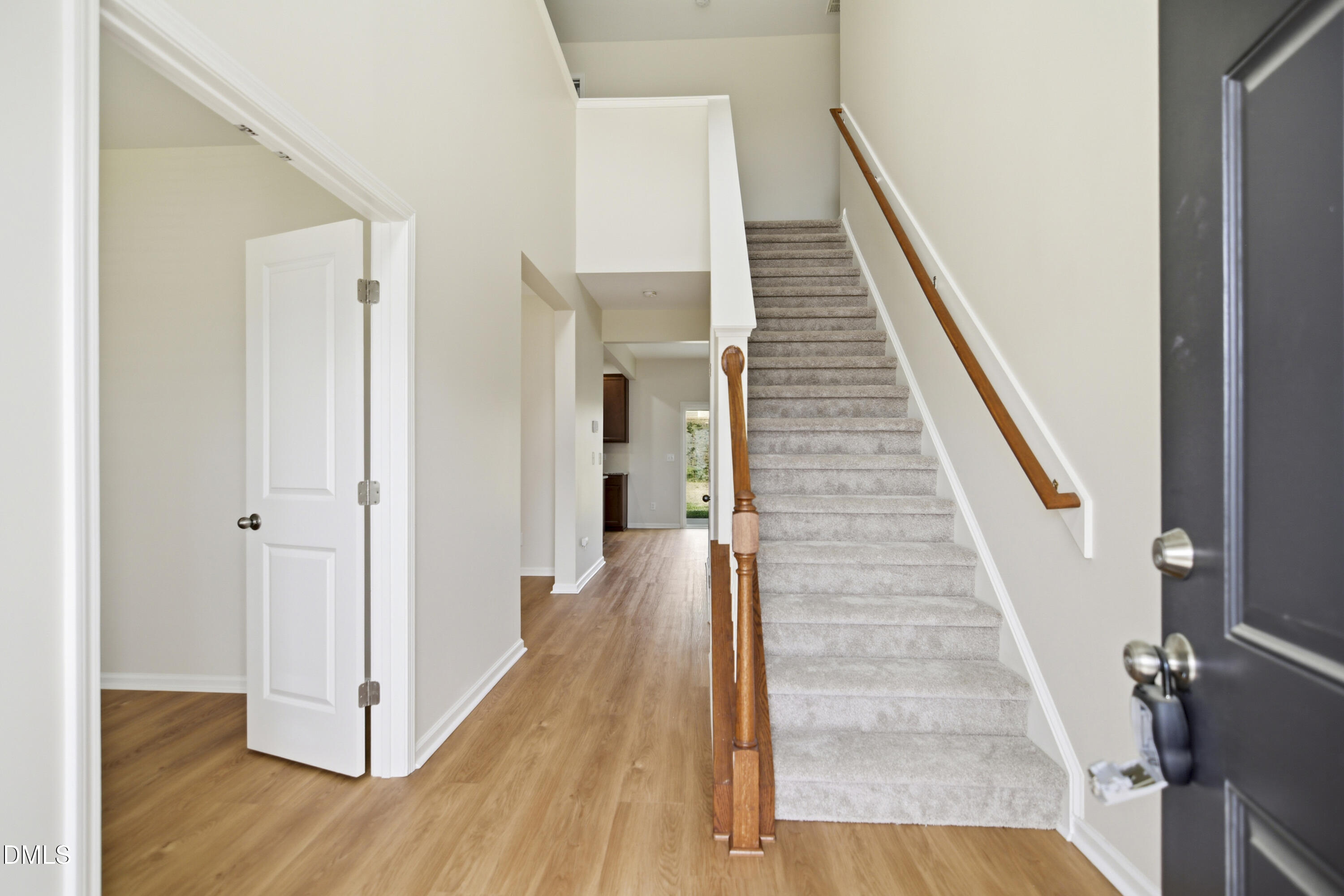 3905 Massey Pointe Court Raleigh, NC 27616 - Photo 11 of 12 a view of a hallway with wooden floor and staircase