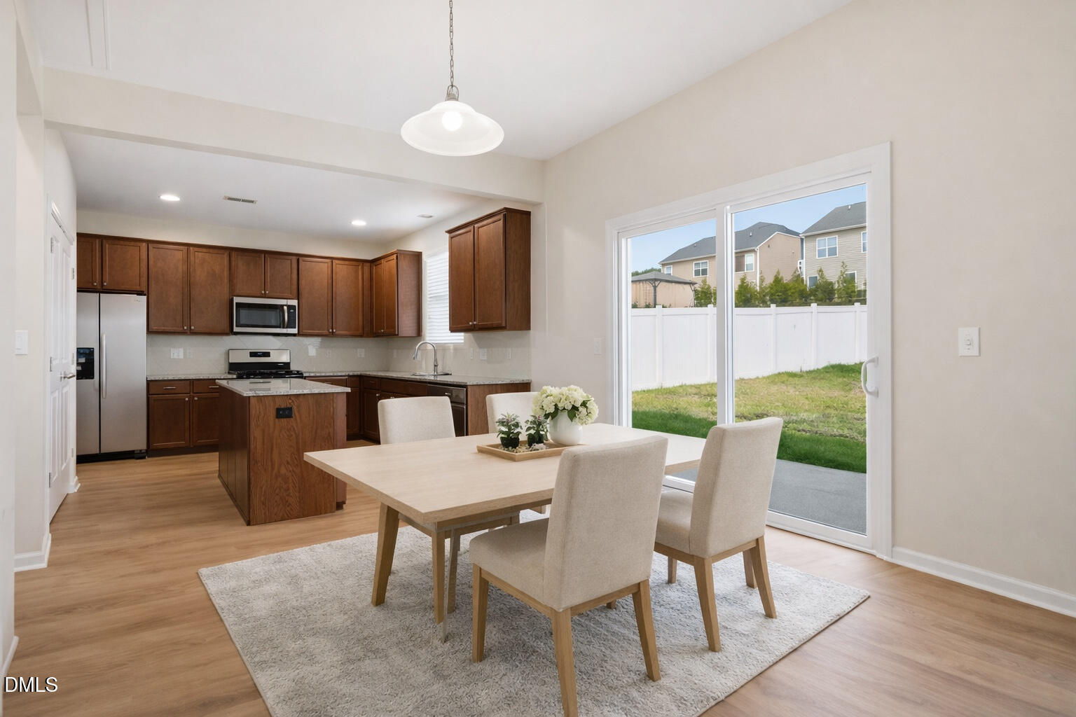 3905 Massey Pointe Court Raleigh, NC 27616 - Photo 3 of 12 a view of a dining room with furniture a chandelier and wooden floor