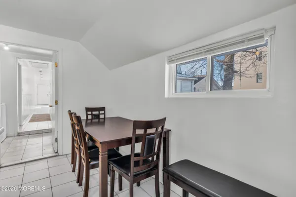 a view of a dining room with furniture and window