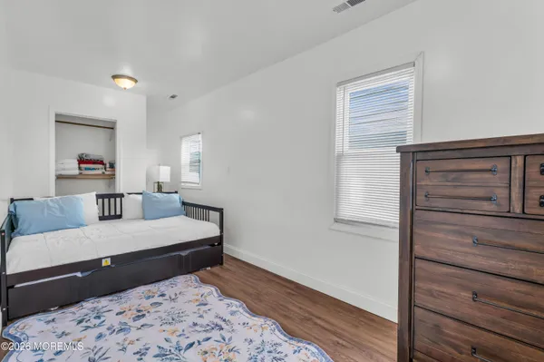 a bedroom with a bed and a dresser