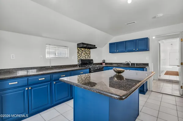 a kitchen with granite countertop a sink and a counter top space